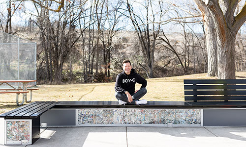 Man sits on completed bench built with ByBlocks