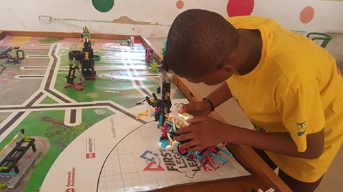 FIRST Lego League student in Nigeria prepares his robot for competition
